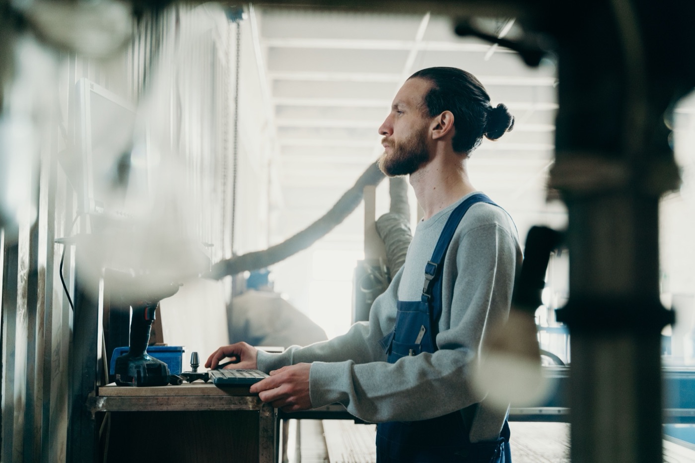An engineer working through a legacy system at a manufacturing workstation
